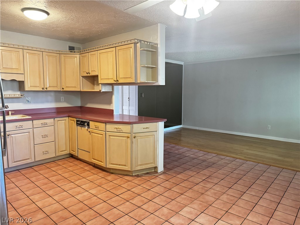 350 East Desert Inn Road, Unit C103 Las Vegas, NV 89109 - Photo 12 of 23 Functional kitchen with ample cabinet space opens to an inviting living area.
