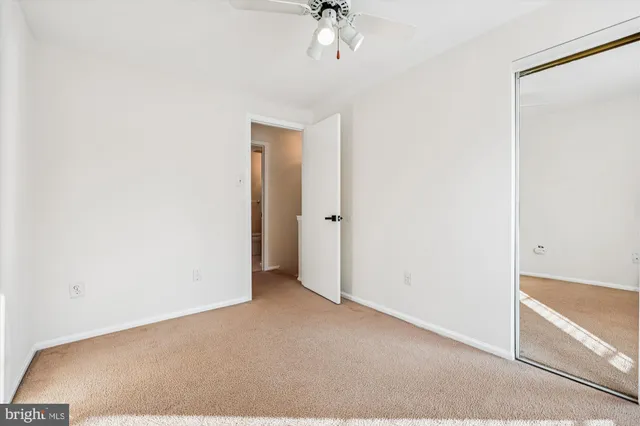 a kitchen with kitchen island a sink dishwasher a stove and white cabinets with wooden floor