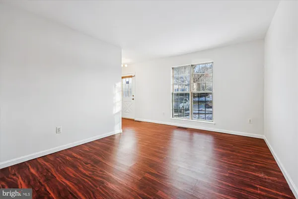 a view of an entryway with wooden floor