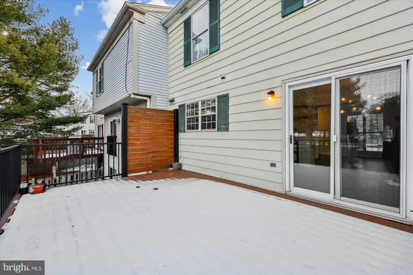 a view of backyard with wooden fence and trees