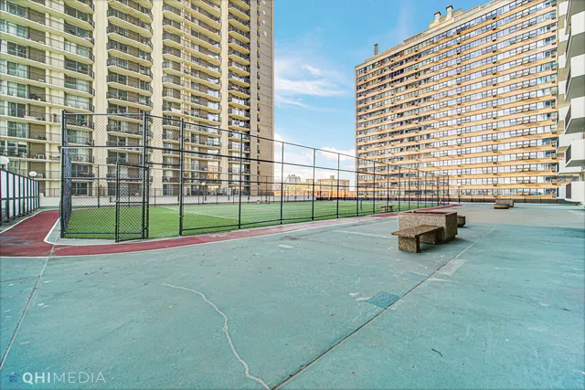 a view of a building with a big yard and many windows