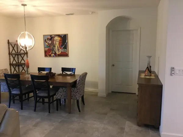 a dining room with furniture and window
