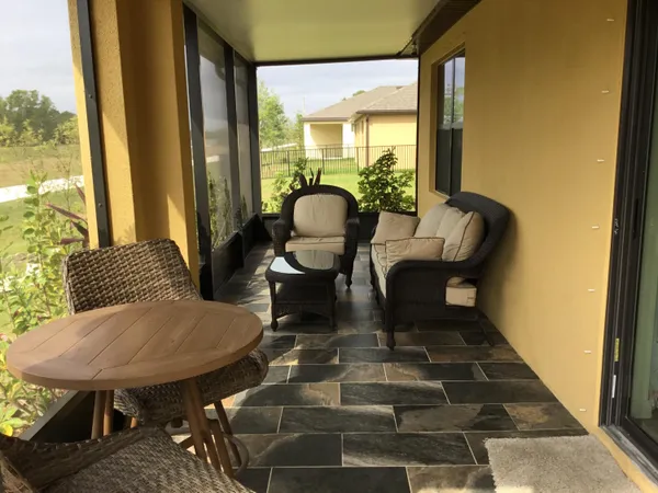 a balcony with furniture and wooden floor