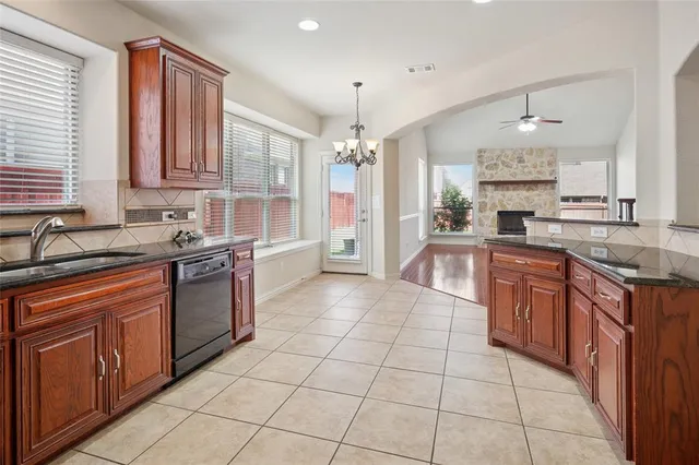 a large kitchen with stainless steel appliances granite countertop a sink and cabinets