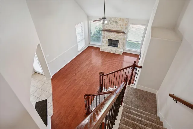 a view of a livingroom with wooden floor and staircase