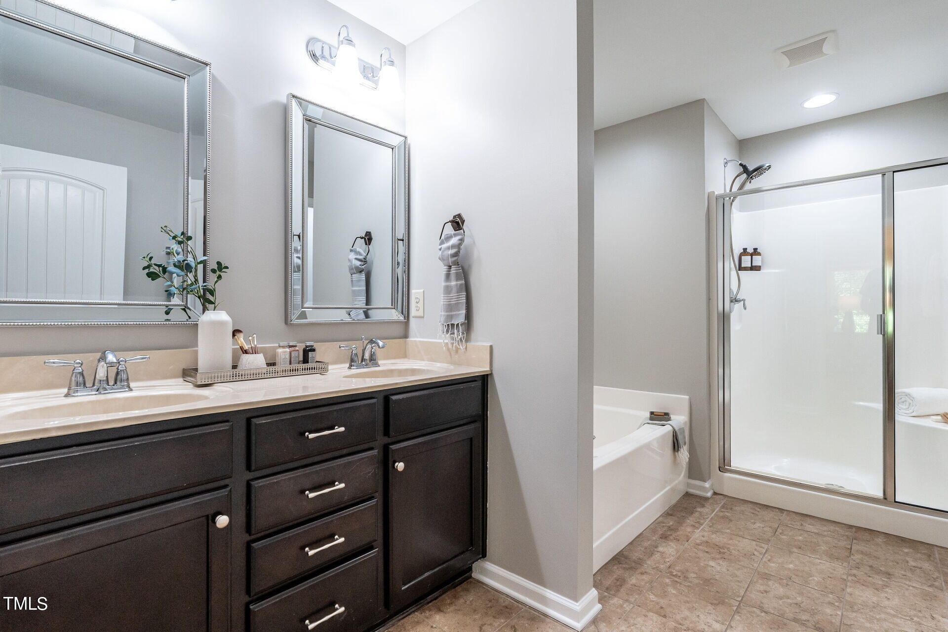 1233 Silver Beach Way Raleigh, NC 27606 - Photo 15 of 26 a bathroom with a double vanity sink mirror double and shower