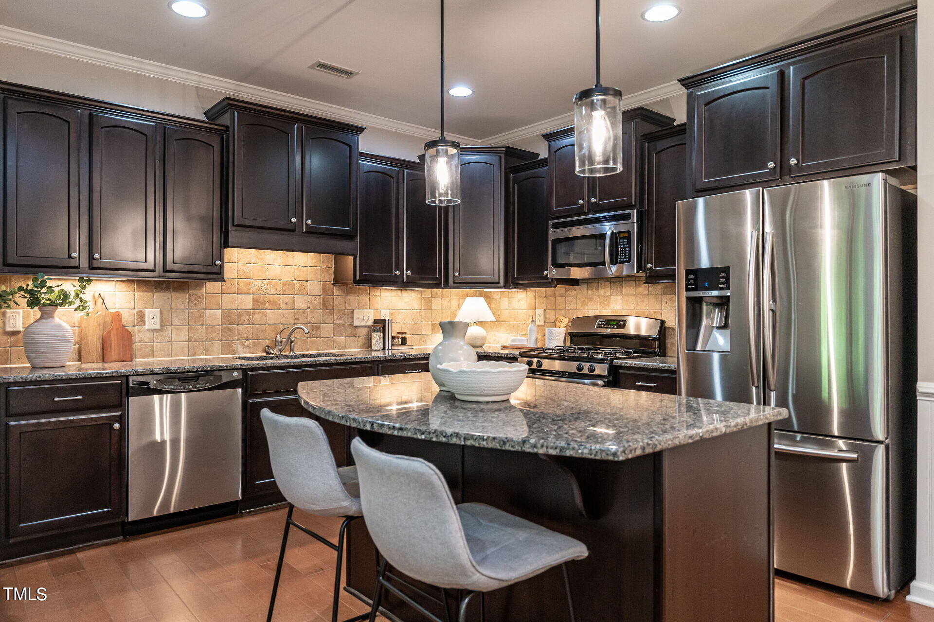 1233 Silver Beach Way Raleigh, NC 27606 - Photo 5 of 26 a kitchen with granite countertop a refrigerator a stove a sink and chairs