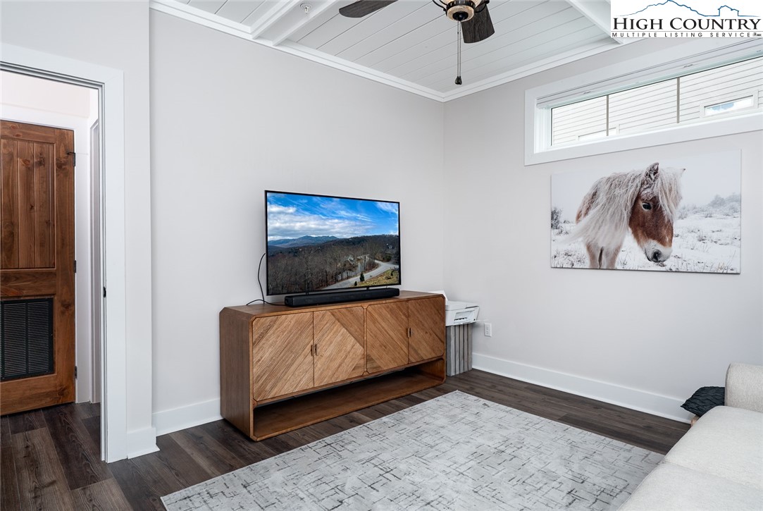 240 Ridgeline Drive, Unit D Sugar Mountain, NC 28604 - Photo 22 of 30 a living room with furniture and a flat screen tv