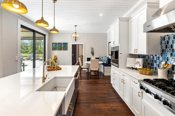 a kitchen with a sink stove and cabinets