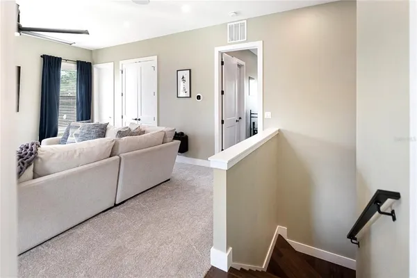 a view of a livingroom with furniture and stairs