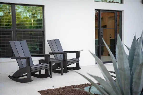 a view of backyard with a table and chairs