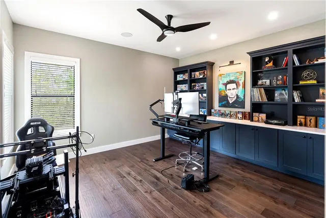 a view of a green field with house in the background