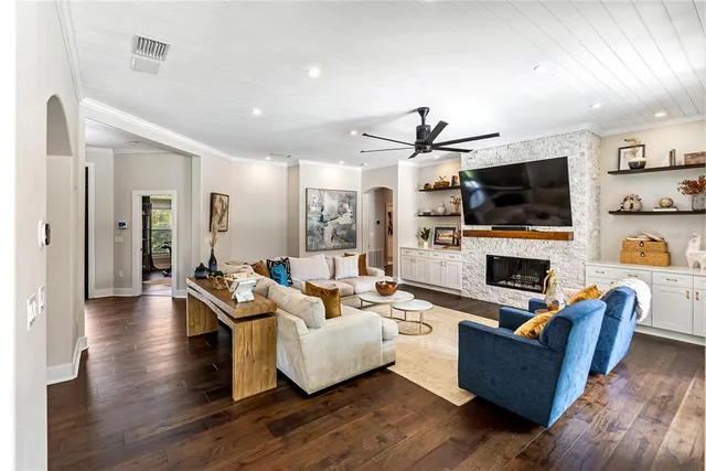 a living room with furniture and kitchen view