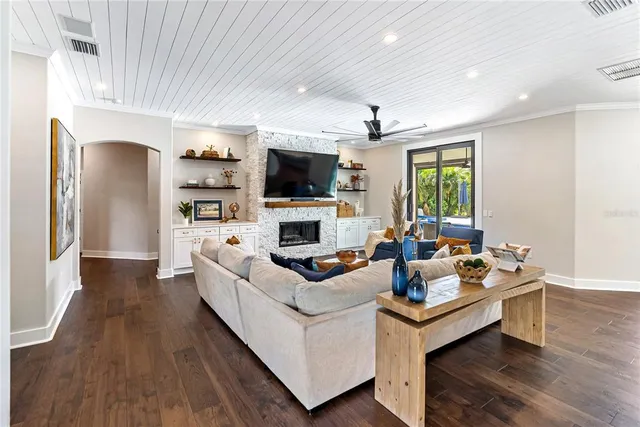 a open kitchen view with stainless steel appliances granite countertop a stove a kitchen island a dining table and chairs