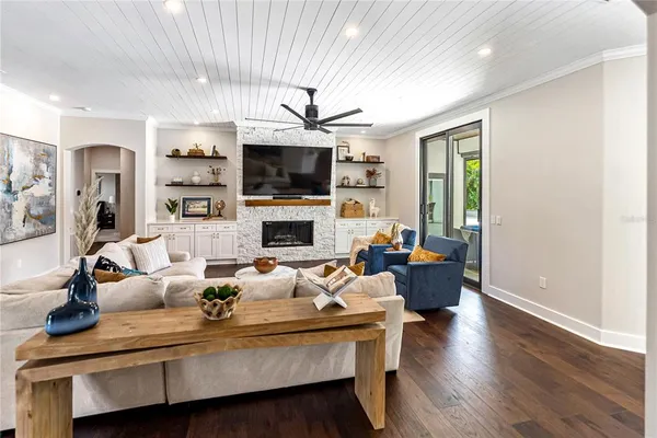 a living room with furniture fireplace and a flat screen tv