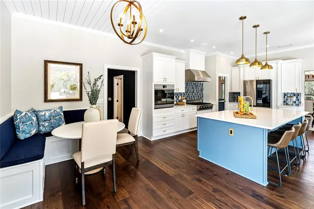 a kitchen with refrigerator a sink and cabinets