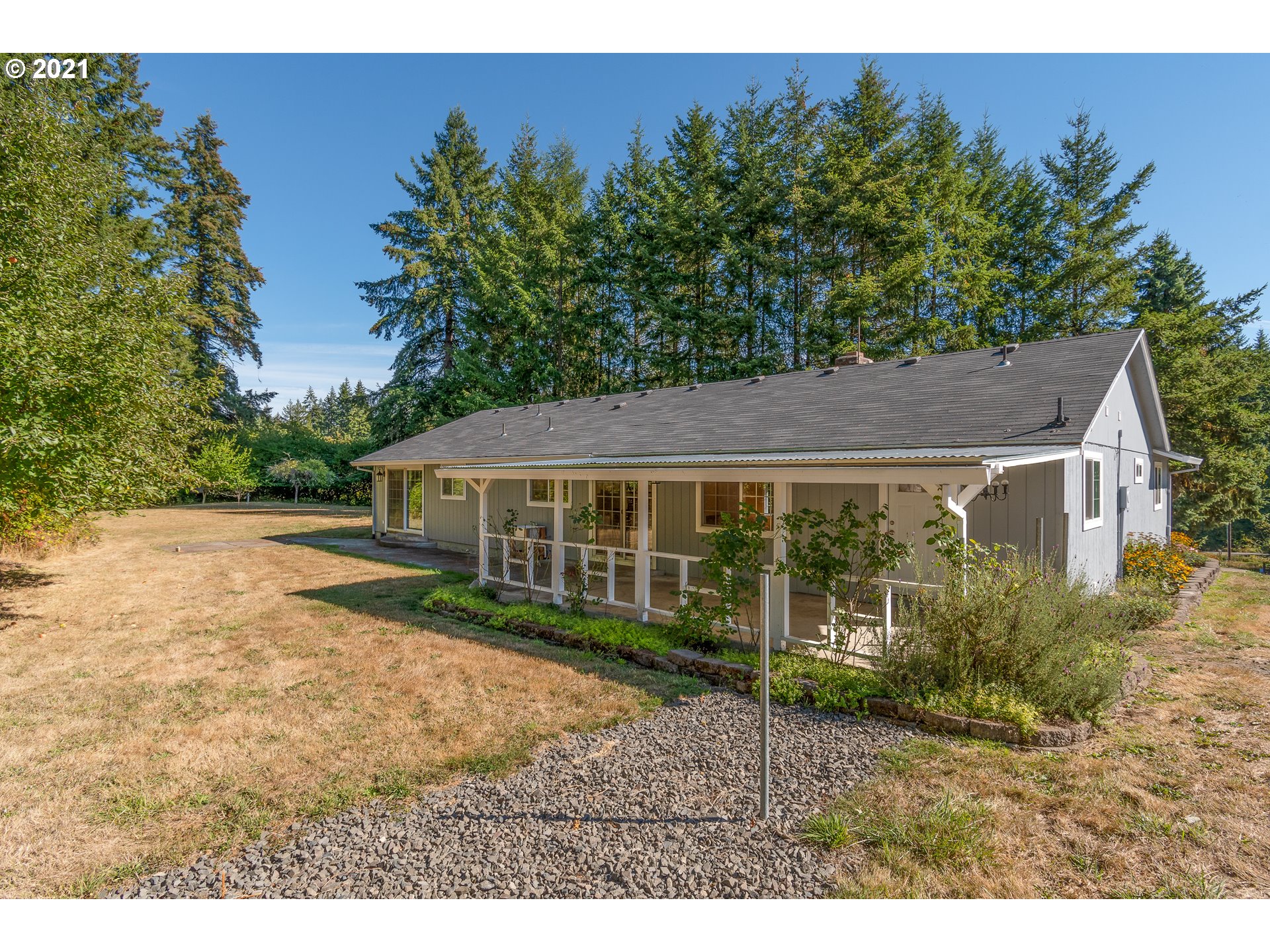69021 Nicolai Road Rainier, OR 97048 - Photo 2 of 32 a view of a yard in front of a house with plants and large tree