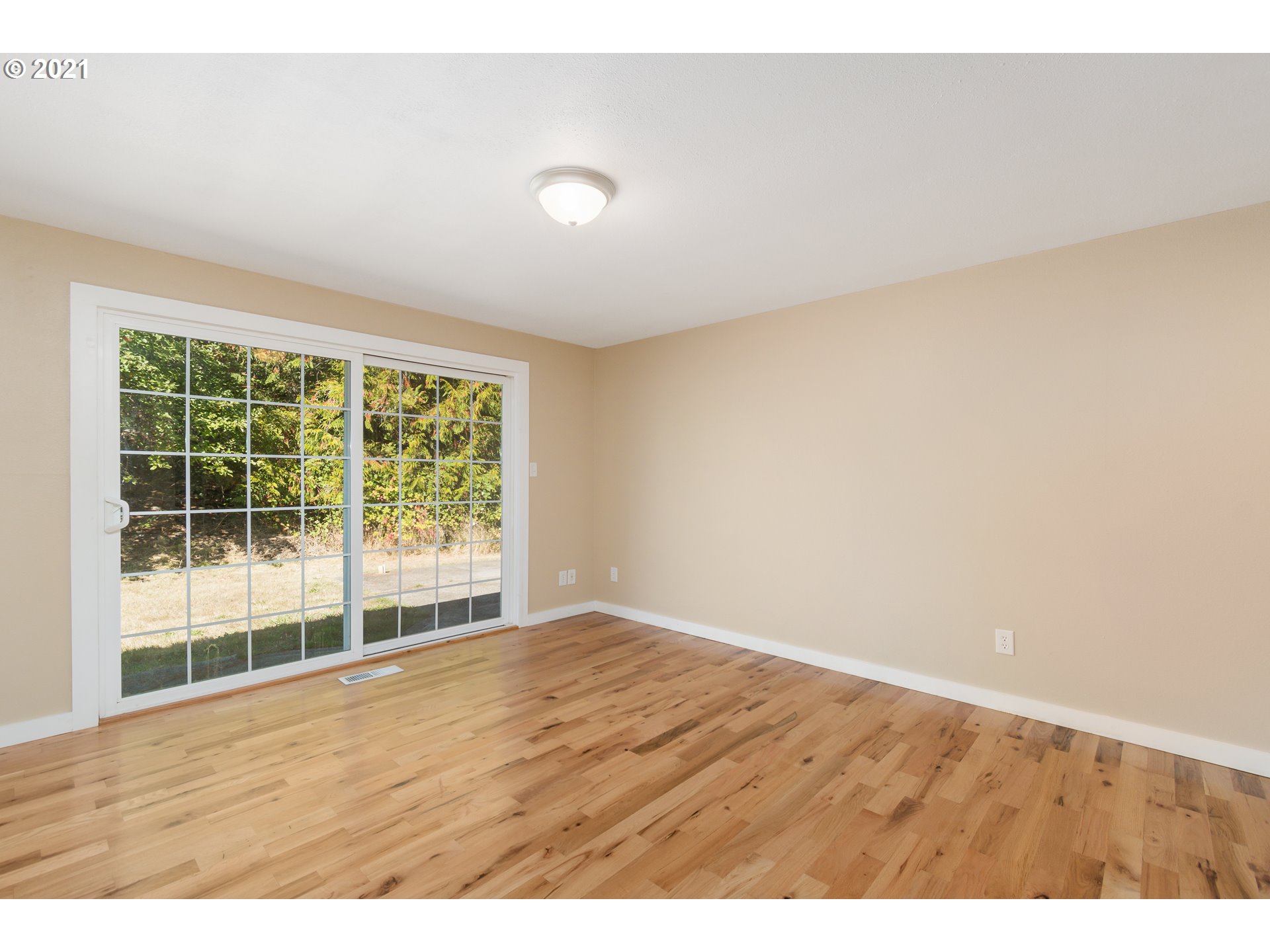 69021 Nicolai Road Rainier, OR 97048 - Photo 19 of 32 a view of an empty room with wooden floor and a window