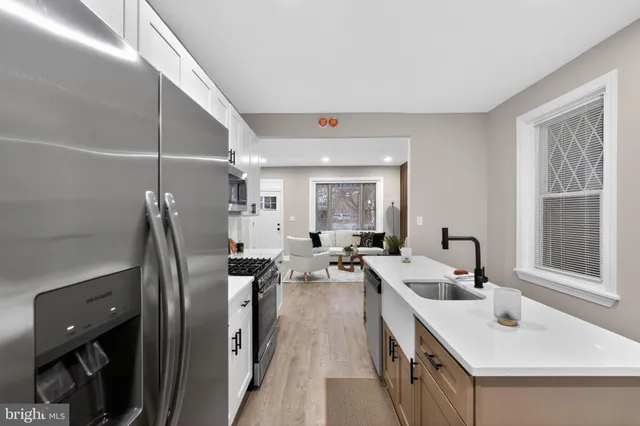 a kitchen with stainless steel appliances a sink a stove and a refrigerator