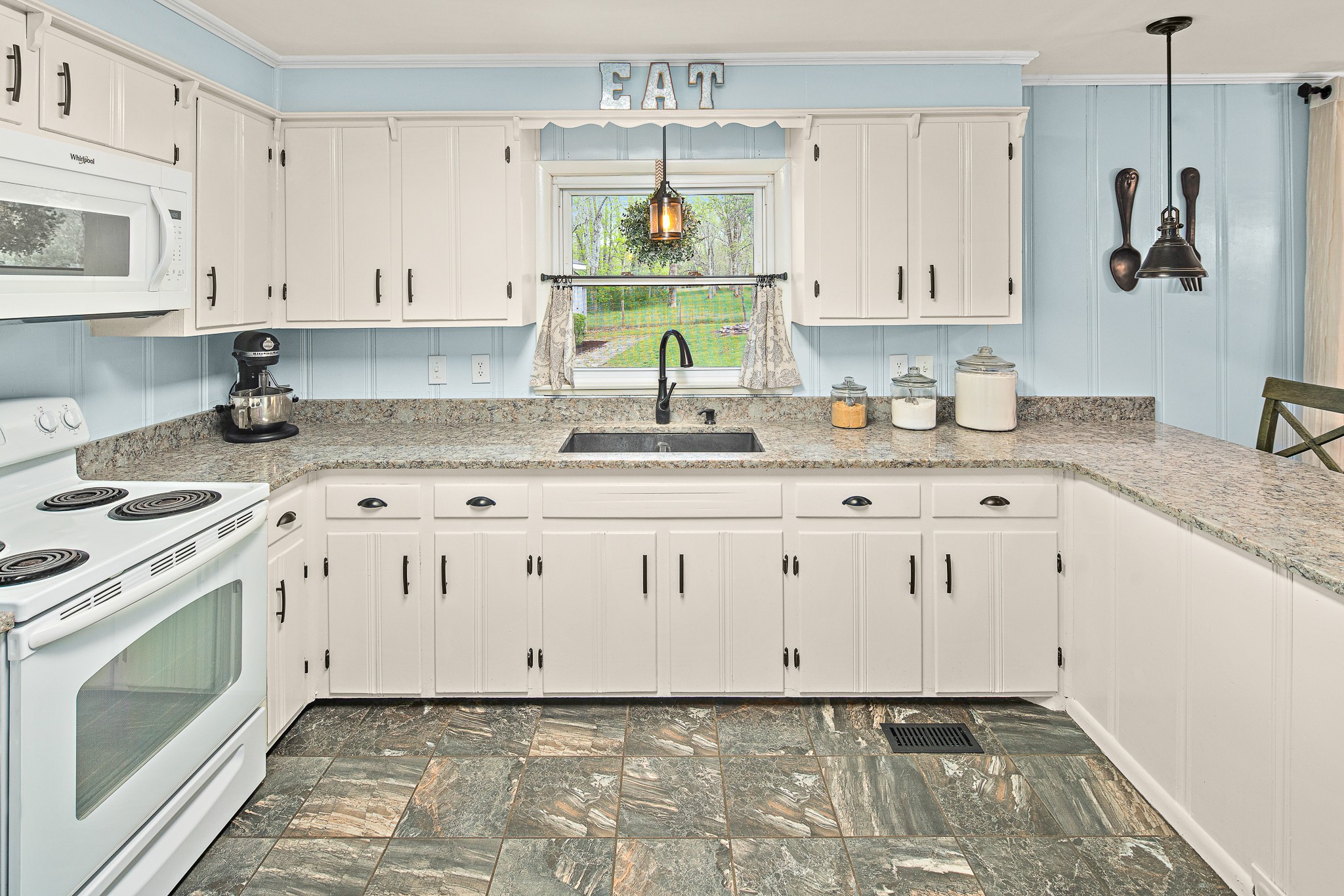 9161 Versailles Road Rockvale, TN 37153 - Photo 12 of 32 a kitchen with granite countertop a sink a stove and cabinets