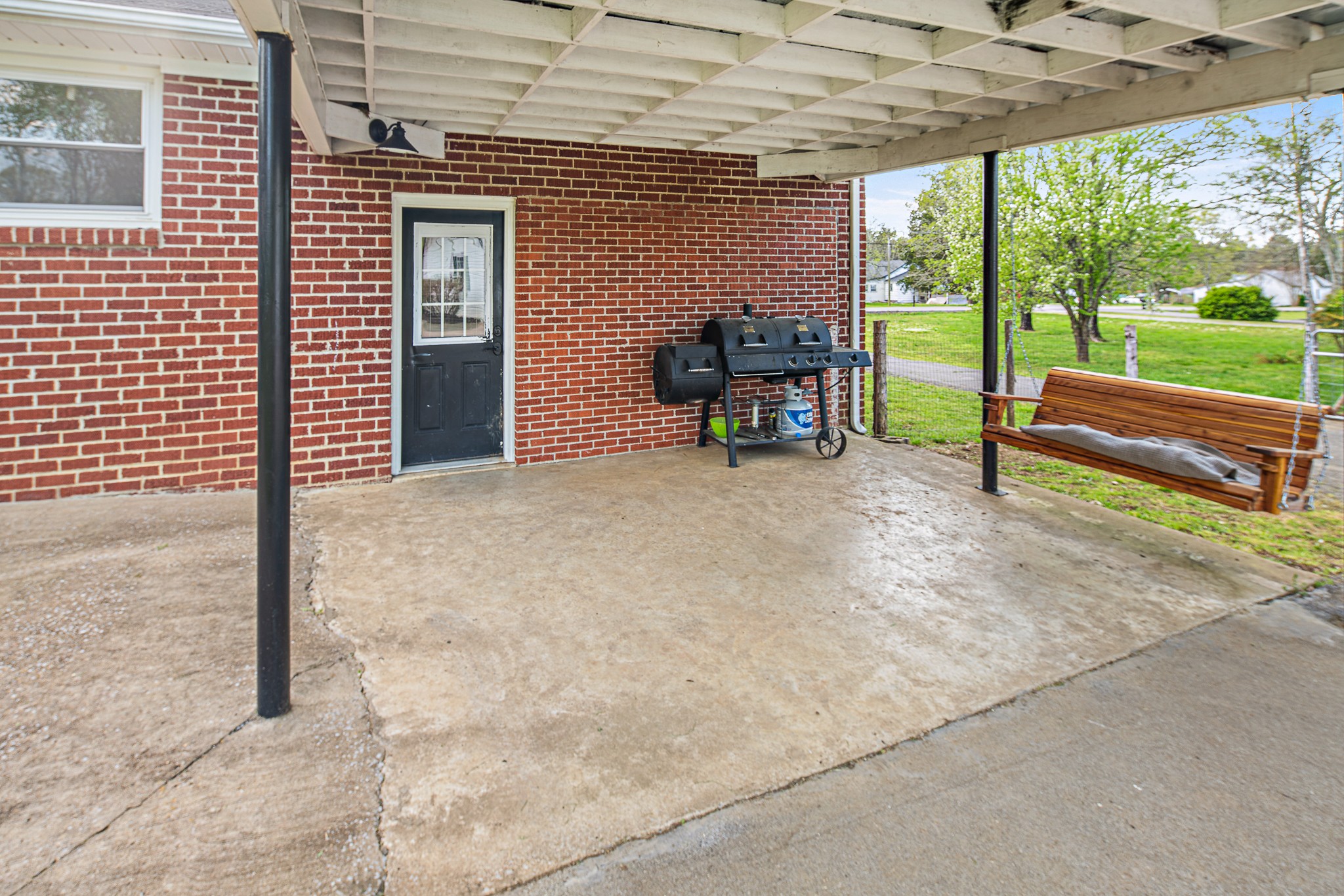 9161 Versailles Road Rockvale, TN 37153 - Photo 28 of 32 a view of a porch with chairs and backyard next to a yard