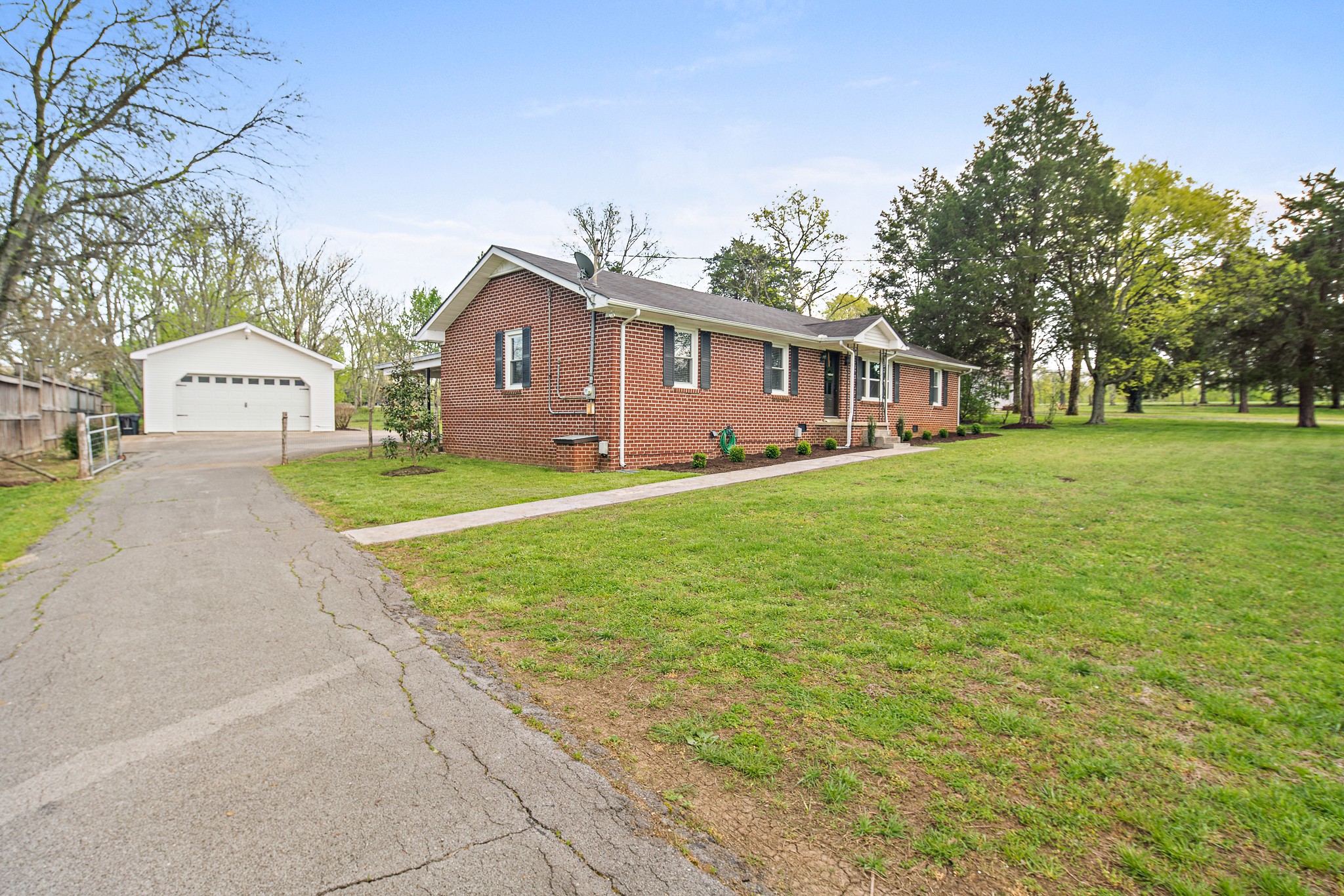 9161 Versailles Road Rockvale, TN 37153 - Photo 3 of 32 a front view of a house with a yard and garage