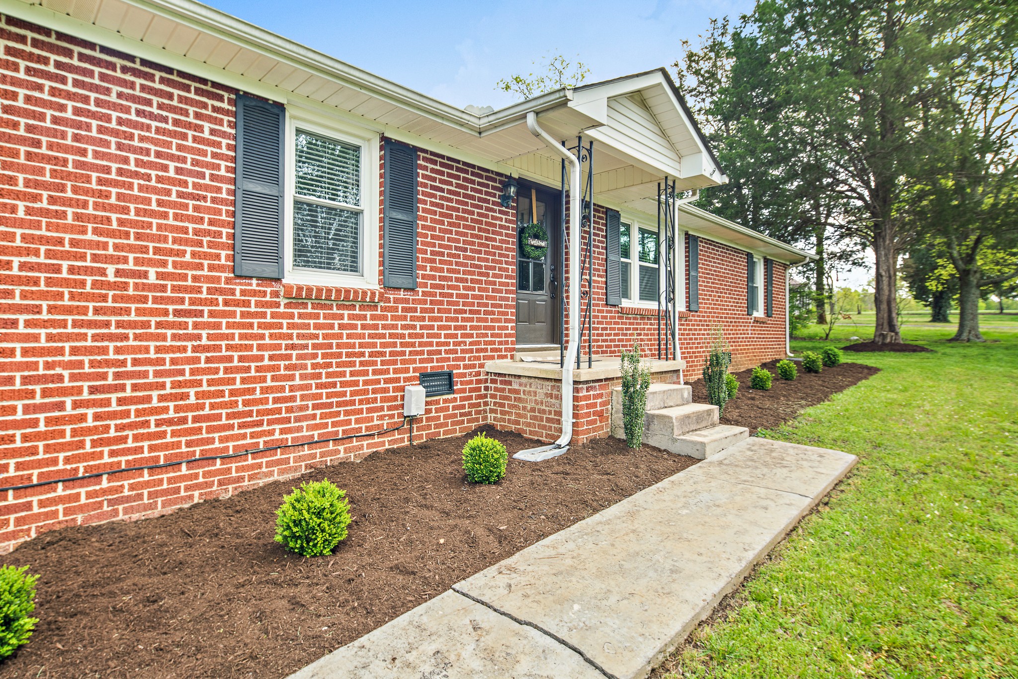 9161 Versailles Road Rockvale, TN 37153 - Photo 5 of 32 a front view of a house with a yard