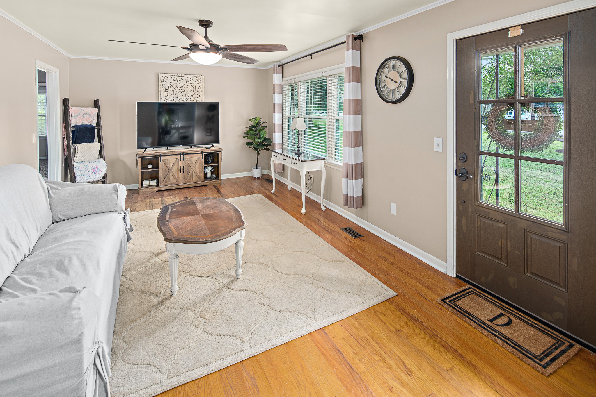 9161 Versailles Road Rockvale, TN 37153 - Photo 7 of 32 a living room with furniture a flat screen tv and a large window