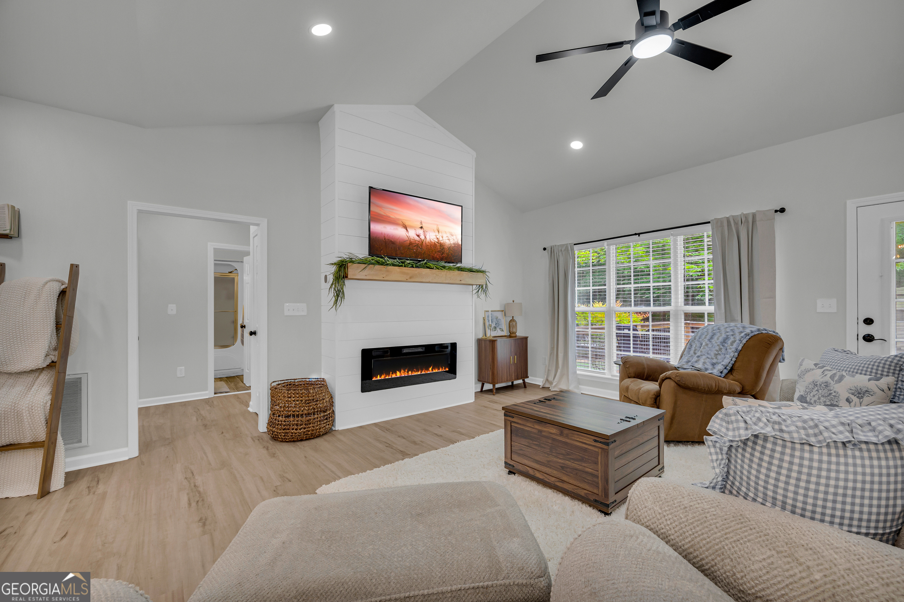 163 Tuxedo Drive Commerce, GA 30530 - Photo 17 of 62 a living room with furniture a fireplace and a flat screen tv