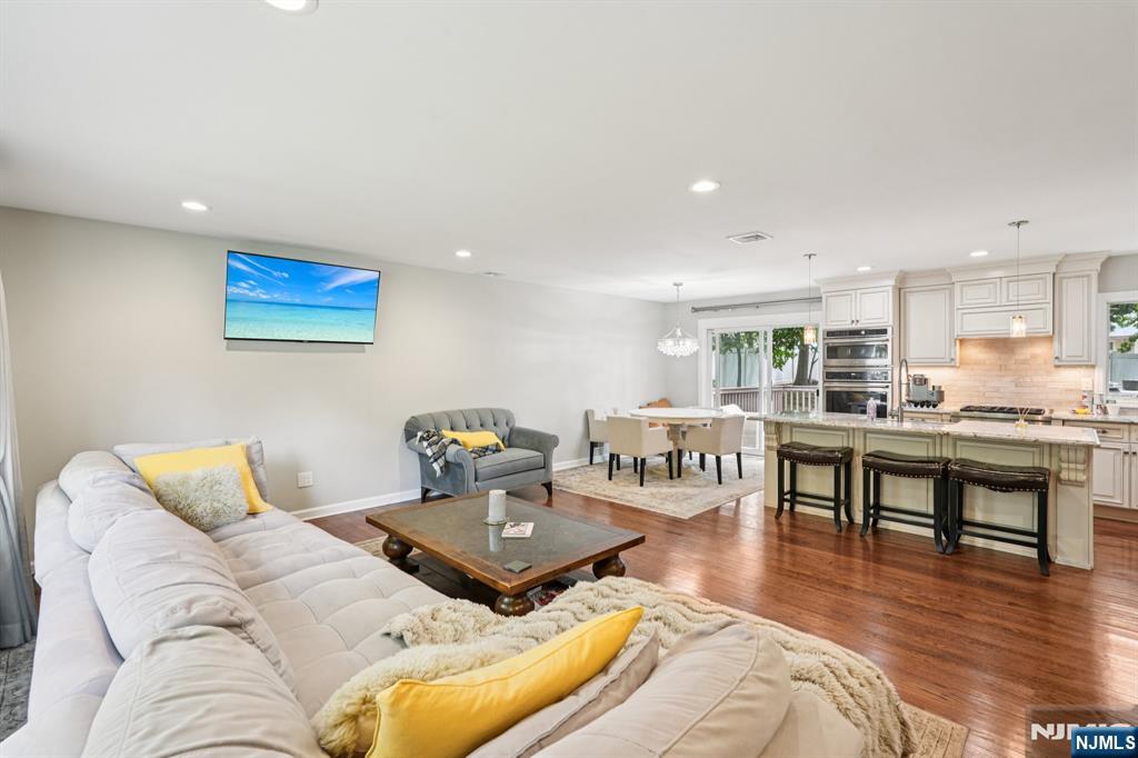 63 Crestmont Road West Orange, NJ 07052 - Photo 11 of 40 a living room with furniture kitchen view and a wooden floor