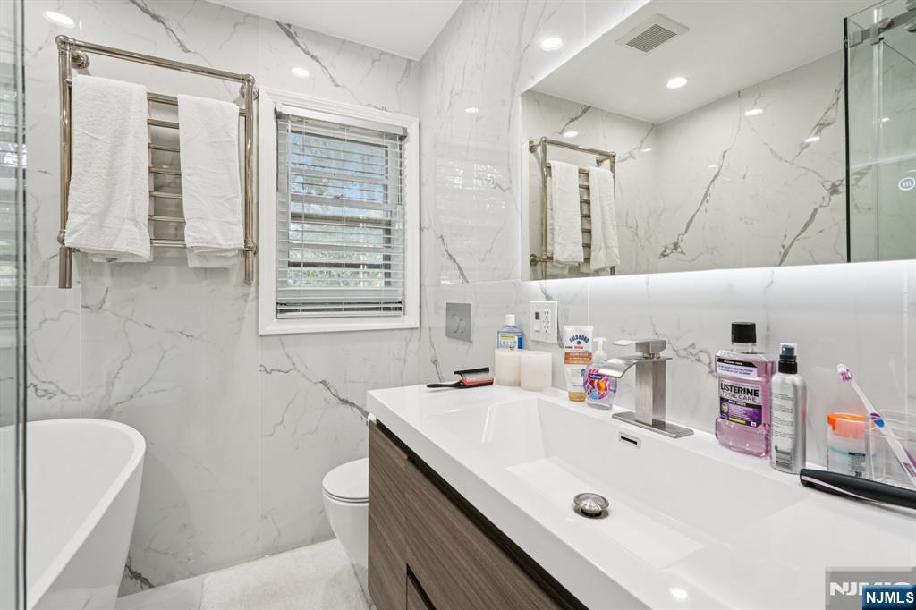 63 Crestmont Road West Orange, NJ 07052 - Photo 15 of 40 a bathroom with a sink a toilet and a bathtub
