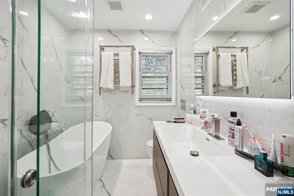 63 Crestmont Road West Orange, NJ 07052 - Photo 17 of 40 a bathroom with a tub sink and mirror