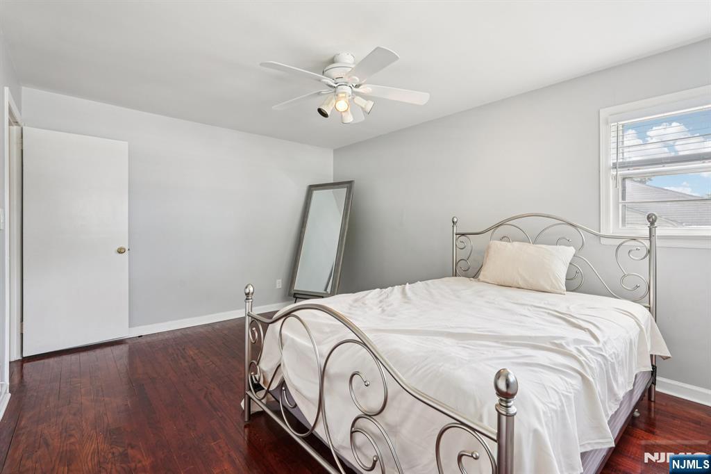 63 Crestmont Road West Orange, NJ 07052 - Photo 23 of 40 a bedroom with a bed and a chandelier