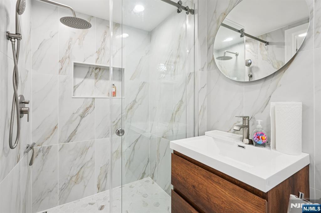 63 Crestmont Road West Orange, NJ 07052 - Photo 26 of 40 a bathroom with a sink vanity and a mirror