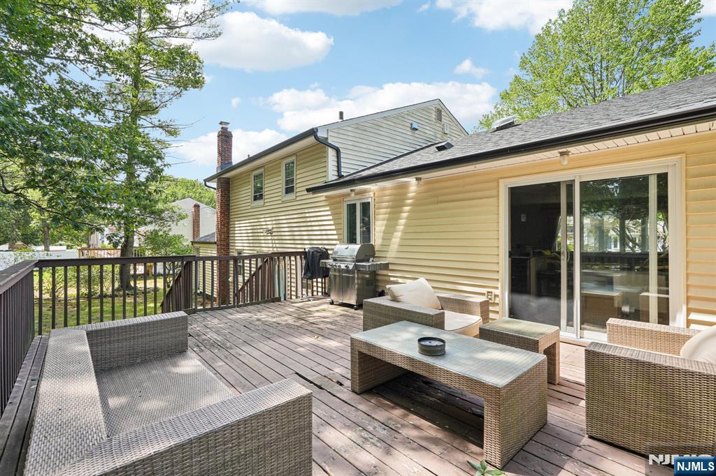 63 Crestmont Road West Orange, NJ 07052 - Photo 30 of 40 a view of a deck with couches table and chairs with wooden floor and fence and a yard