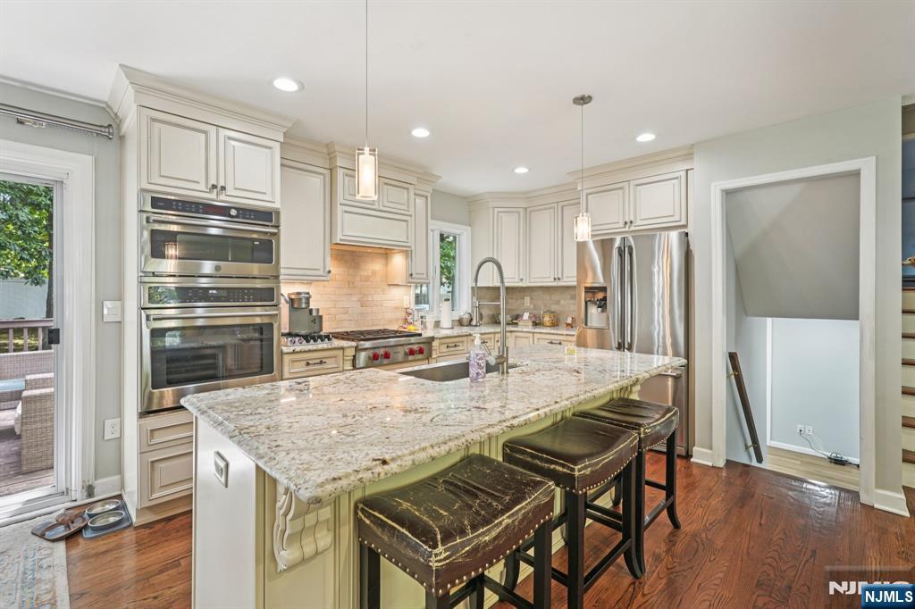 63 Crestmont Road West Orange, NJ 07052 - Photo 5 of 40 a kitchen with a table chairs refrigerator and microwave