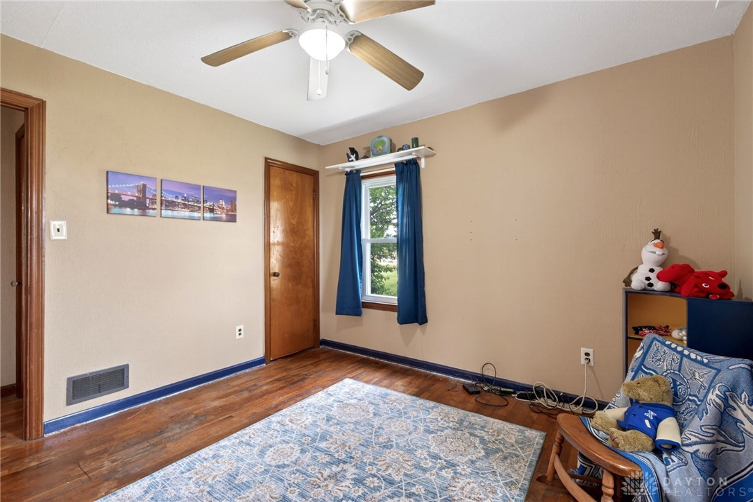 2470 Clark Run Road Xenia, OH 45385 - Photo 28 of 57 This cozy bedroom features warm wood floors and abundant natural light, perfect for peaceful living.