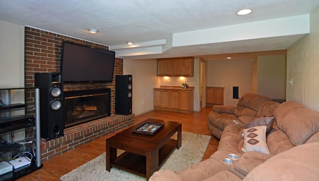 1995 O'Block Road Plum, PA 15239 - Photo 15 of 20 The basement is finished with recessed lighting, a wood-burning fireplace with brick chimney, powder room, and a dry bar with cabinets.
