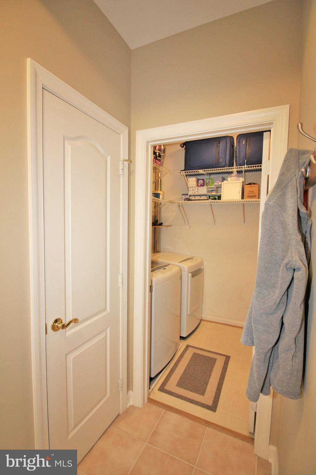 20901 Cedarpost Square, Unit 301 Ashburn, VA 20147 - Photo 22 of 25 Coat closet & laundry room
