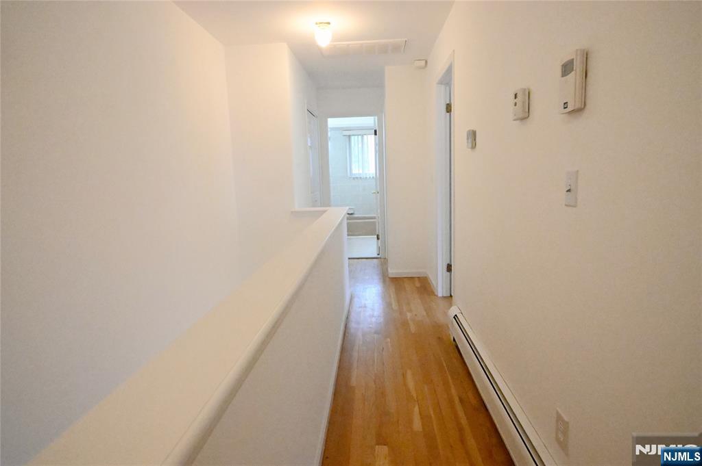 436 Brinkerhoff Avenue, Unit RIGHT Fort Lee, NJ 07024 - Photo 5 of 10 a view of a hallway with wooden floor and a bathroom