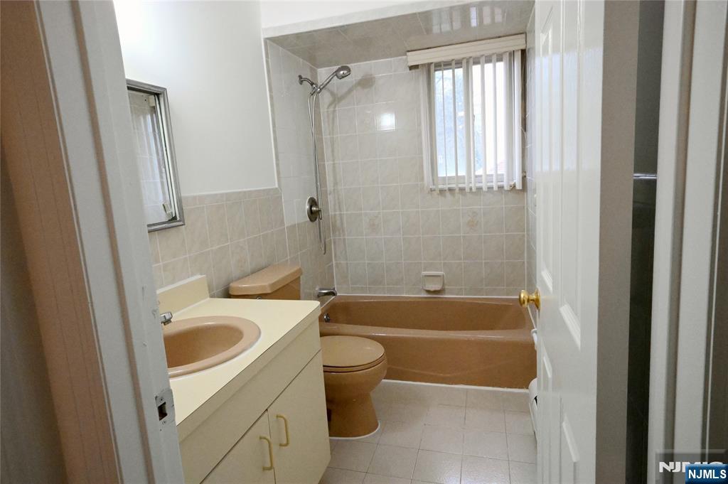 436 Brinkerhoff Avenue, Unit RIGHT Fort Lee, NJ 07024 - Photo 6 of 10 a bathroom with a sink a toilet and bathtub