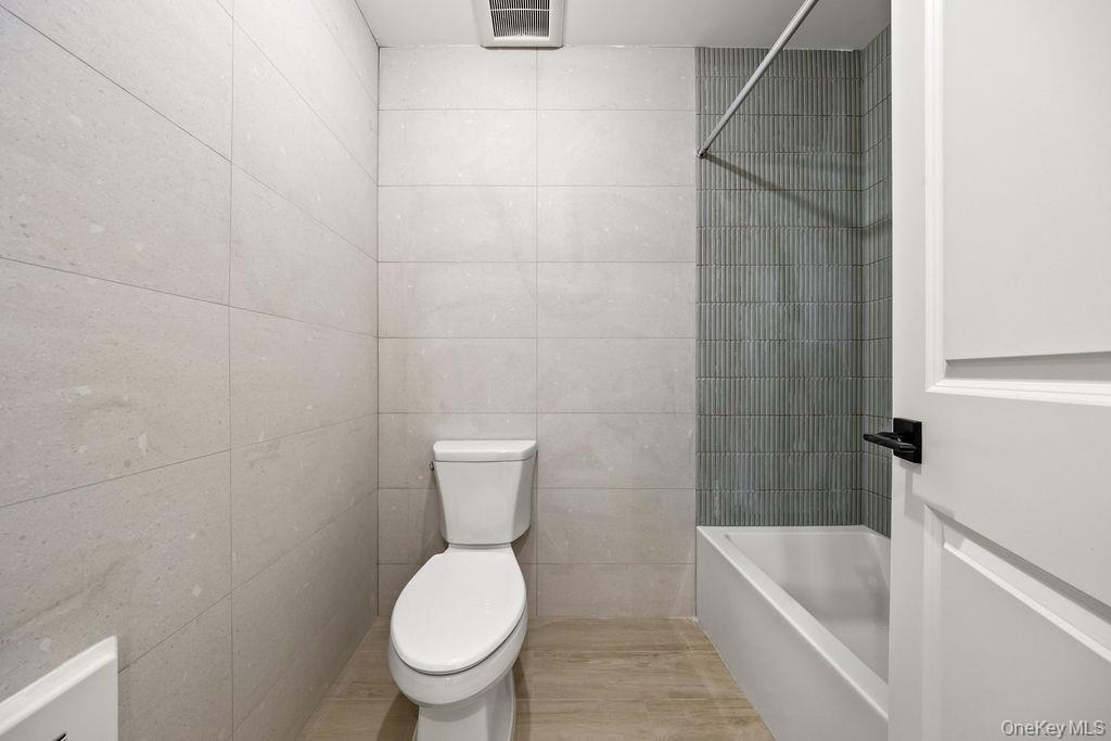 62 Blauvelt Road, Unit 202 Monsey, NY 10952 - Photo 29 of 34 a white toilet sitting next to a bathtub