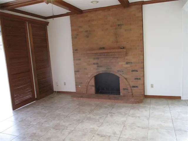 a view of an empty room with a fireplace