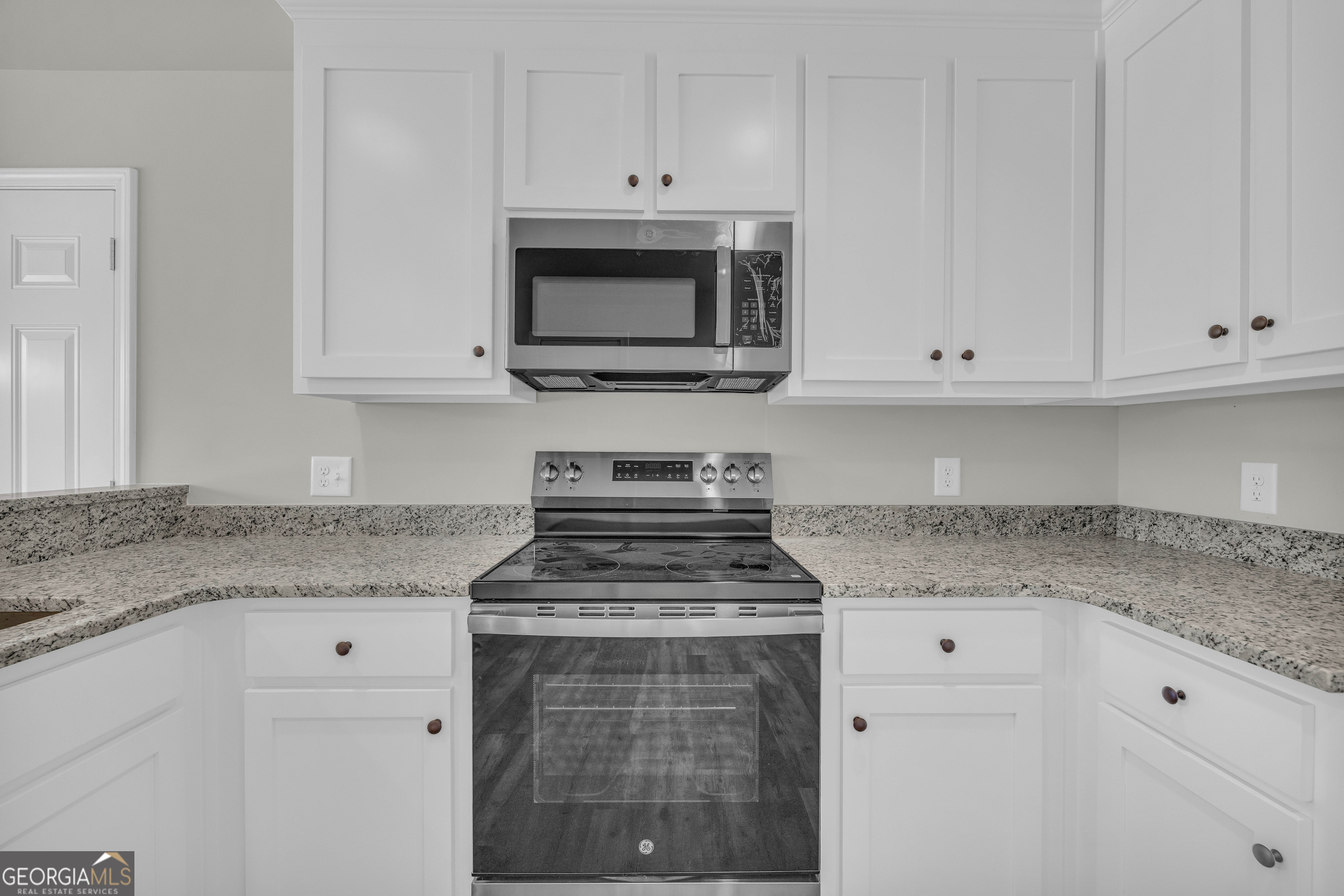 62 Sewell Road Lavonia, GA 30553 - Photo 15 of 63 a kitchen with white cabinets and appliances