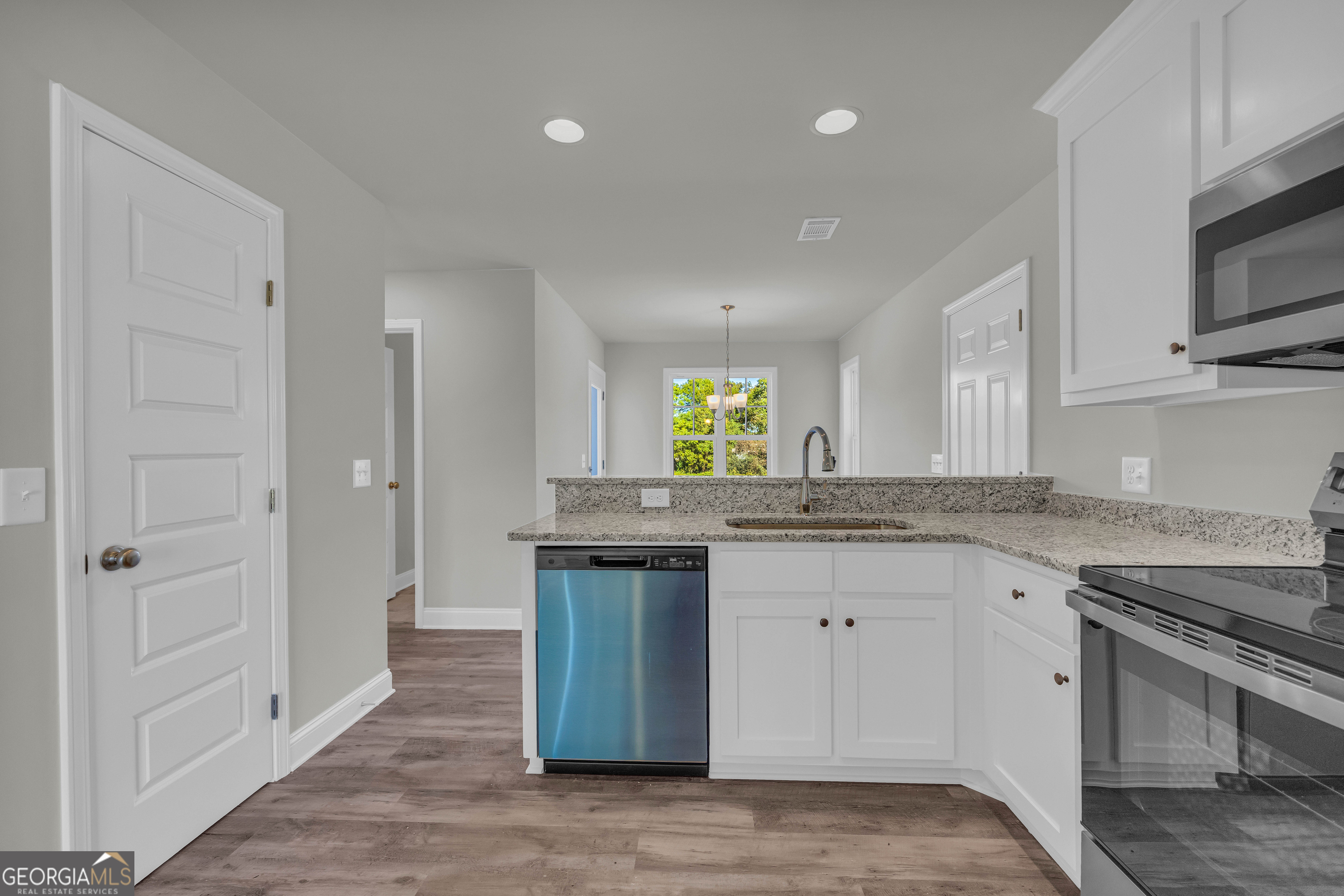 62 Sewell Road Lavonia, GA 30553 - Photo 16 of 63 a kitchen with stainless steel appliances granite countertop a sink and stove top oven