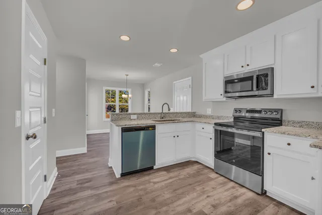 a view of a room with wooden floor staircase and a chandelier