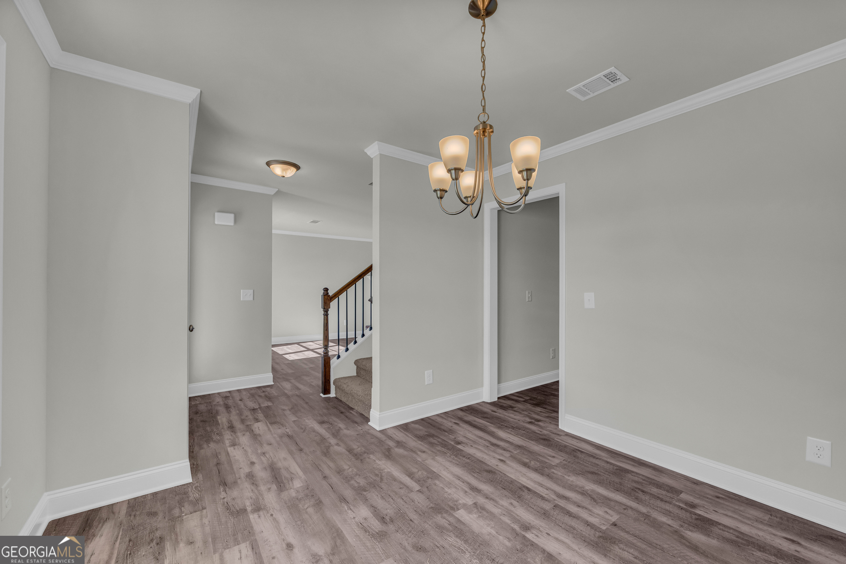 62 Sewell Road Lavonia, GA 30553 - Photo 22 of 63 a view of a room with wooden floor staircase and a chandelier