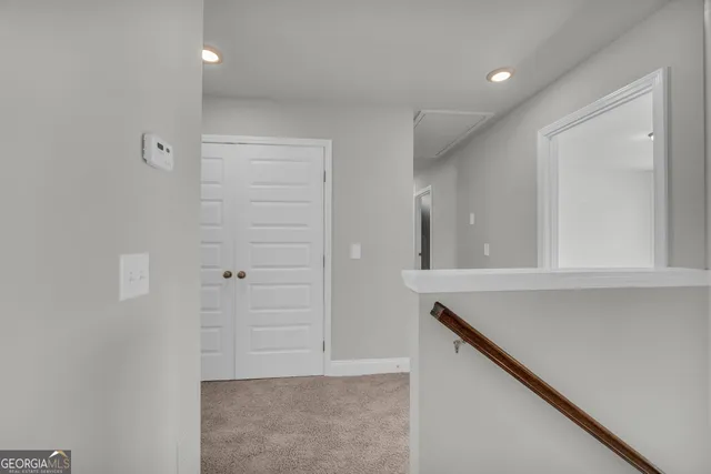 an empty room with windows and ceiling fan