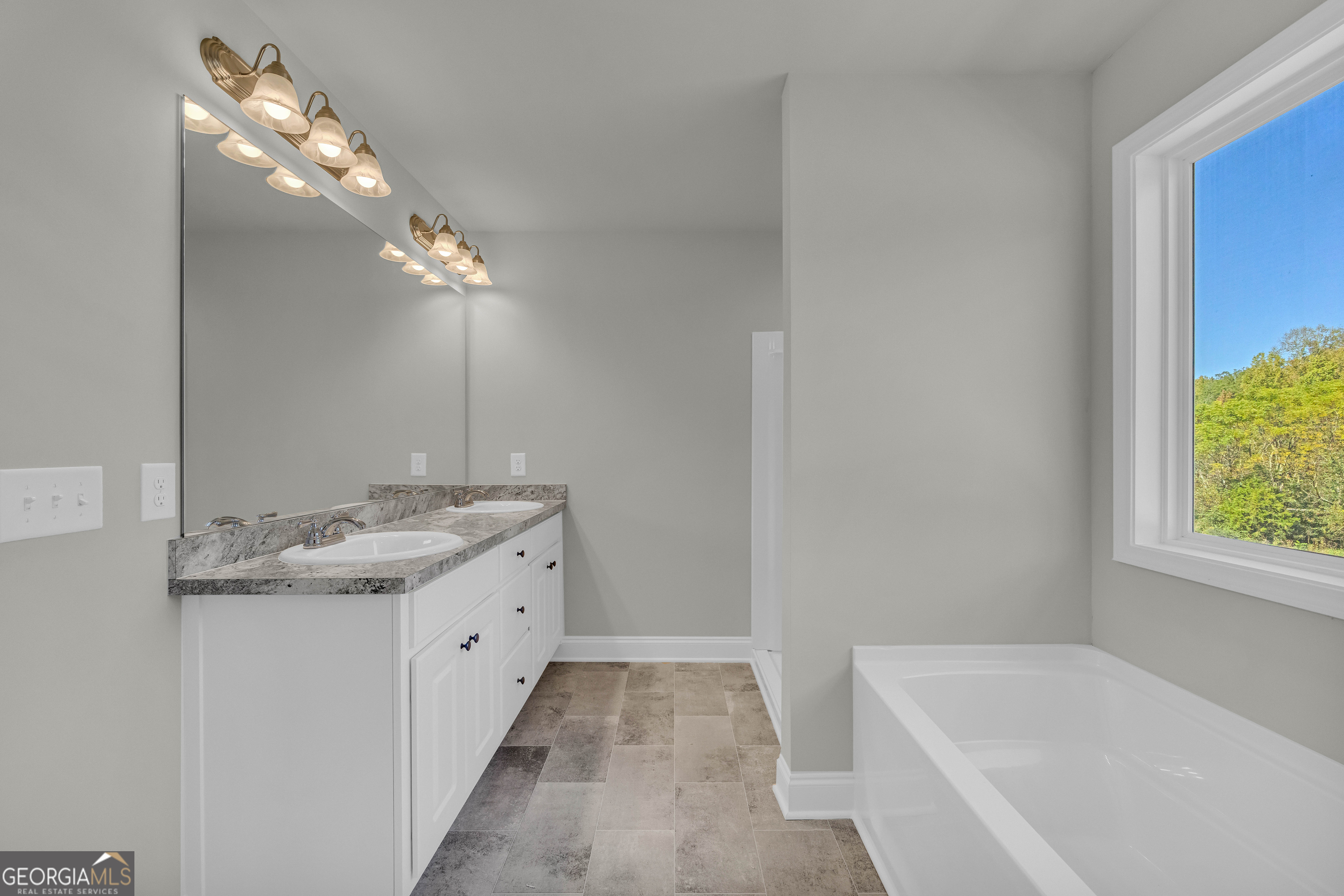 62 Sewell Road Lavonia, GA 30553 - Photo 38 of 63 a bathroom with a granite countertop bathtub a sink and a mirror