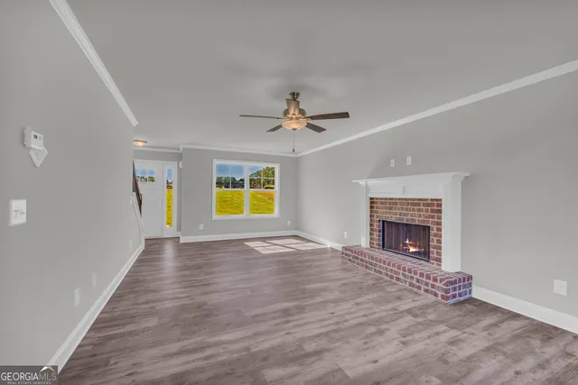 wooden floor in an empty room with a fireplace